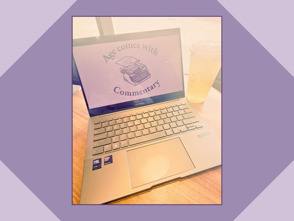 A close-up of a laptop displaying the vintage typewriter logo for the "Age comes with Commentary" blog.